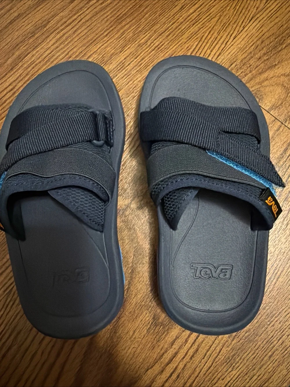 Teva Black Slide Sandals with Blue Accent